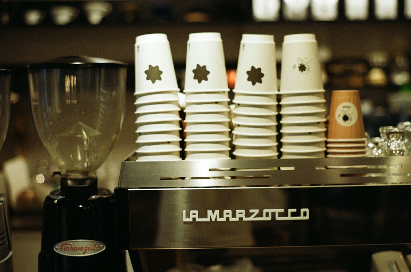 Professional espresso machine and coffee grinder on a cafe counter.